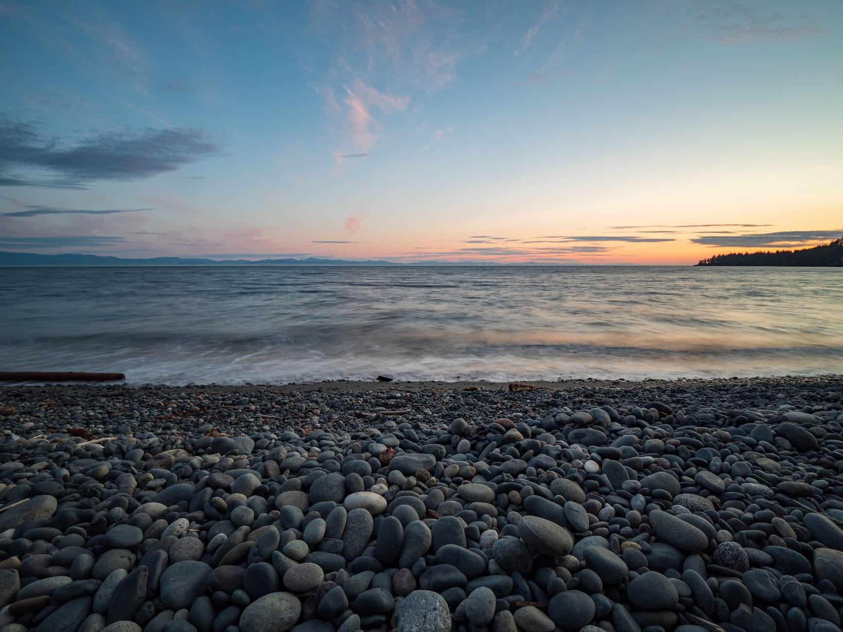 stones on seashore during sunset
