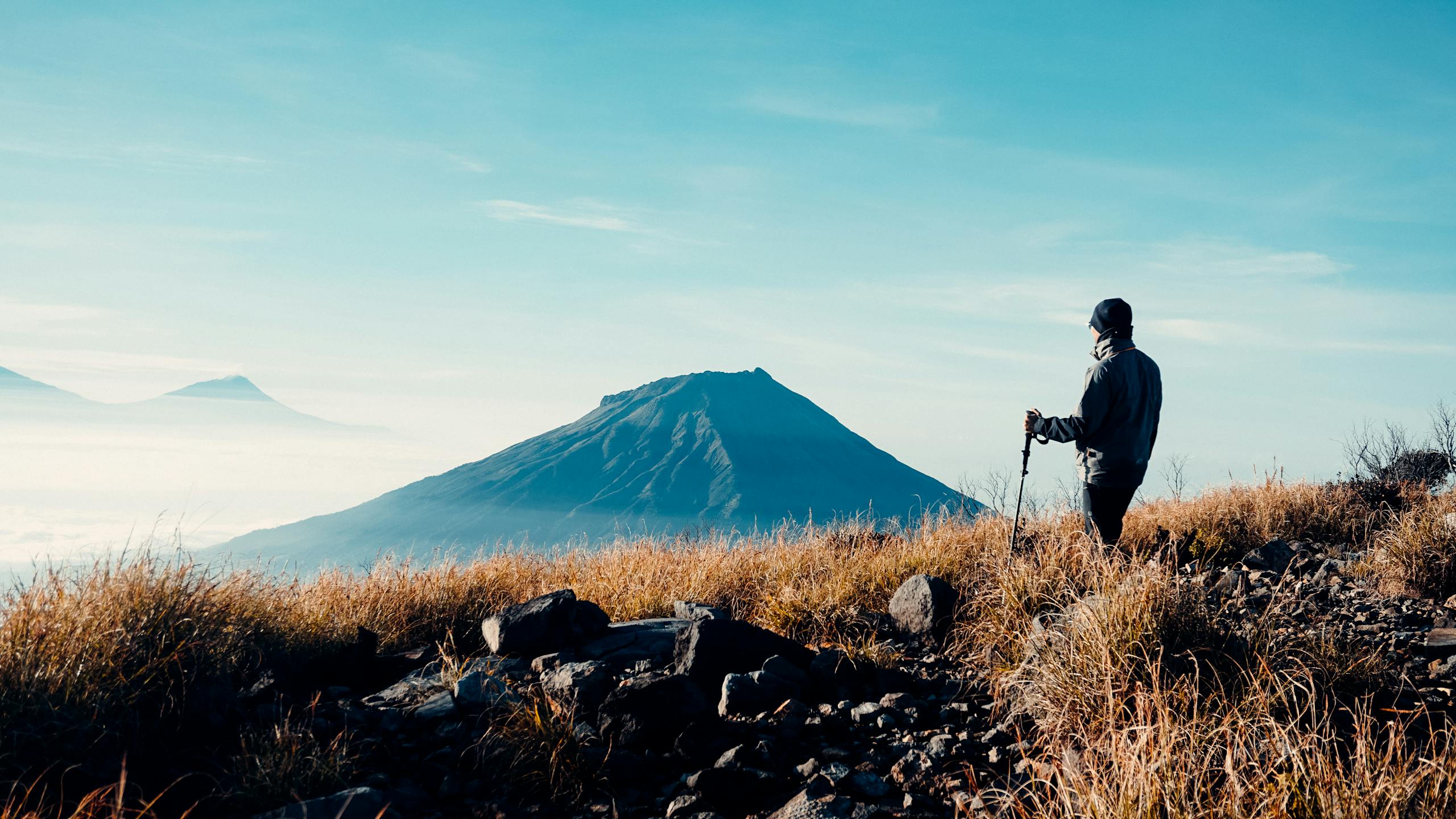 Mt. Sumbing view from the top of Mt. Sindoro and a guy hiking to do stealth camping